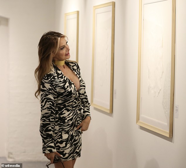 Browsing: Lizzie is seen looking at her Australian friend Valerie's minimalist art exhibit, which will be on display at Noho Studios through Sunday
