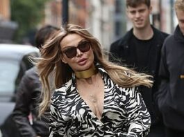 Fabulous!  Lizzie Conde puts on a penny show as she heads to an art gallery in Soho, London, on Friday to launch her friend's exhibition.