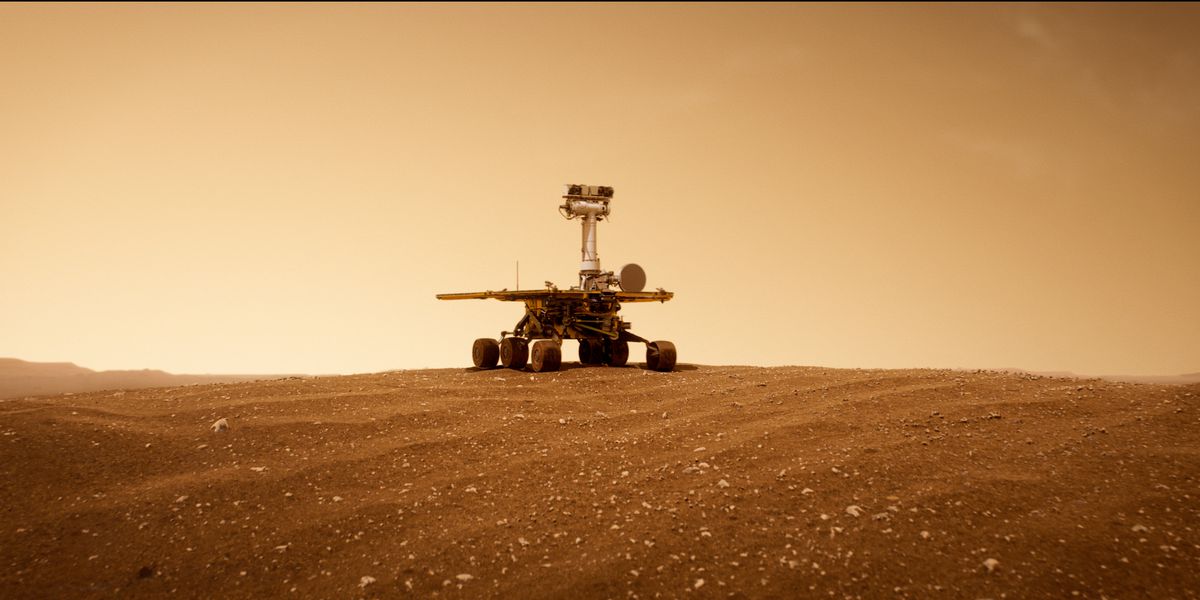 A remote-controlled rover drone idling on the plains of a Martian dune.
