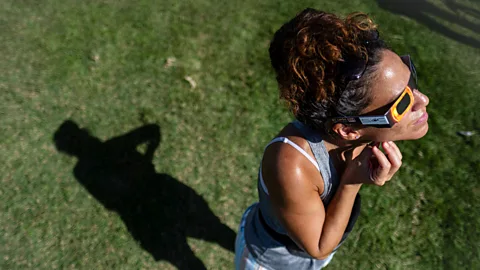 Getty Images An eclipse observer wearing safety glasses